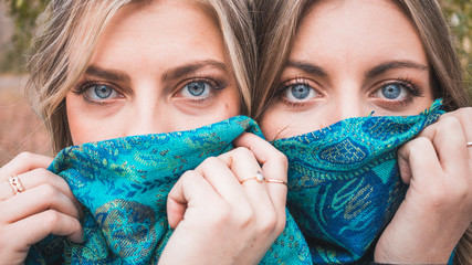 Closeup of gorgeous blonde women with blue eyes and blue scarf