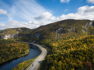 Aerial panoramic view of a scenic road during a vibrant sunny day. Taken near Corner Brook, Newfoundland, Canada.