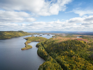 Fototapeta na wymiar Aerial panoramic view of a beautiful lake during a vibrant sunny day. Taken in Newfoundland, Canada.