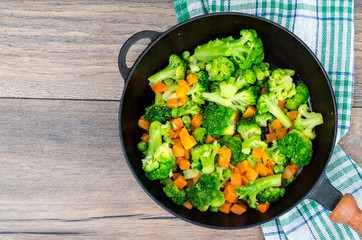 Vegetarian dish. Broccoli, carrots, green peas in pan
