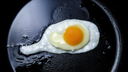 Fresh fried egg in a griddle. Scrambled eggs.
