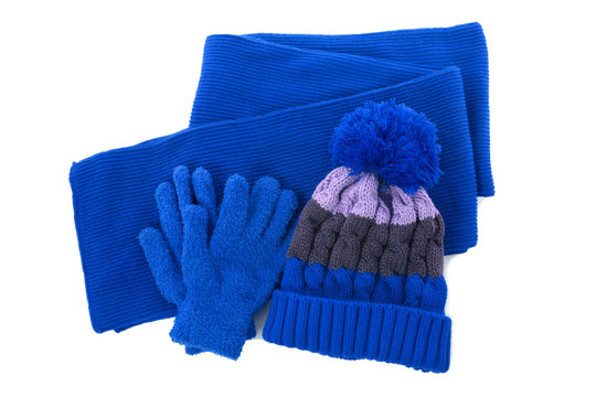 Blue winter knitted bobble hat, scarf gloves isolated