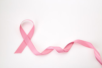 Obraz na płótnie Canvas Curled Pink Ribbon On White
