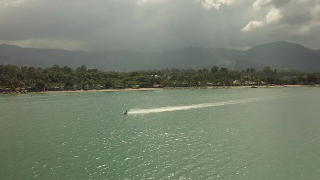 Single Water Jetscooter racing along beach - kom samui