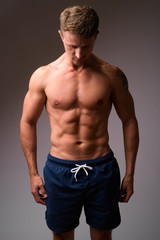 Fototapeta premium Muscular handsome bearded man shirtless looking down