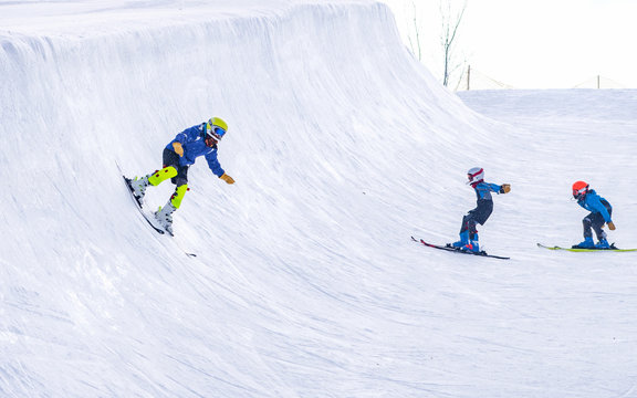 People are enjoying half-pipe skiing	/ snowboarding	