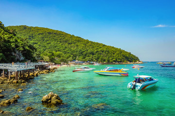 Naklejka na ściany i meble Tropical Idyllic Ocean and Boat on Koh lan Island in vacation time. Koh lan island is the Famous island near Pattaya city the Travel Destination in Thailand,Thailand holiday concept