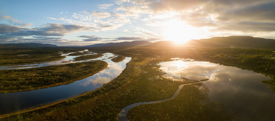 Aerial landscape view of a beautiful river during a sunny sunrise. Taken in Codroy Valley, Newfoundland, Canada.