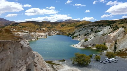 This photograph was taken during my road trip in New Zealand. This place looks very surreal as if it was located in other planet. The lake is extreme beautiful. The cliffs and sky are stunning.