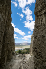 A small narrow gap to a breathtaking view. This image is suitable to express achieving goal, route,...
