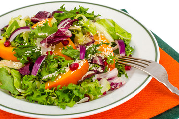 Salad with persimmon and sesame seeds, healthy food.