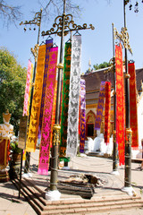 Thai people and foreign travelers hanging holy flags or colorful Tung Flag of Lanna or northern of thai for respect praying at Wat Phra That Doi Tung in Chiang Rai, Thailand