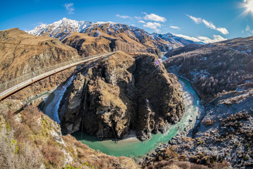 Located in New Zealand's South Island, the Skippers Canyon Road is known for its scenic roads, and scary narrow road. There are steep sheer cliff face. Below is the famous shotover river stream. - Powered by Adobe