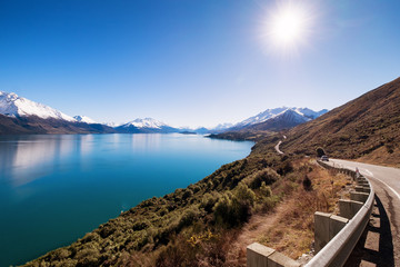 Obraz na płótnie Canvas This stretch of road is very famous in New Zealand. It links Queenstown to Glenorchy. Along this road, one can enjoy beautiful scenery like river, mountain, and spectacular views.