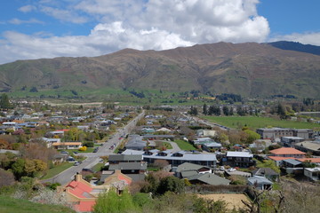Fototapeta na wymiar Houses of New Zealand. This shot is taken from the top of a hill. You can see road connections, small houses and infrastructure. Every tiny details make up the town.