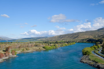 This photo is taken during road trip in New Zealand. The view is amazing. The river is extremely blue.