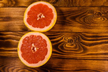 Fototapeta na wymiar Ripe juicy grapefruit on a wooden table. Top view