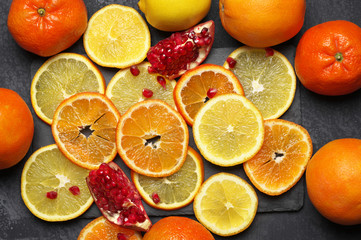 Whole and sliced citrus fruits