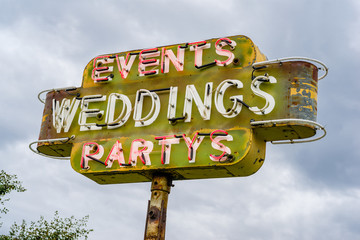 Fifties style roadside neon sign advertising weddings, events & party venue