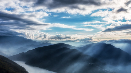Taken on the peak of a mountain in Taiwan, one can see layers and layers of mountain ranges from the distance. The light rays are strong and stunning. The image is perfect for background use.