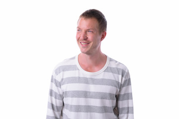 Obraz premium Young happy handsome man thinking isolated against white background