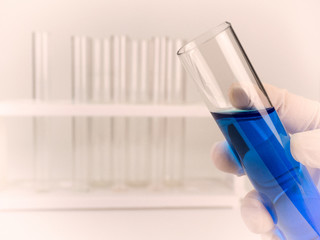 chemist holding a test-tube.