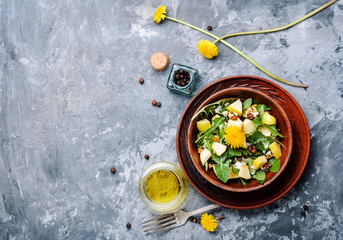 Salad with dandelions flowers,cucumber, arugula and carrot.Fresh vegetable salad