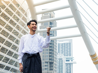 Young Burmese businessman happy after using mobile phone to find a data for his business