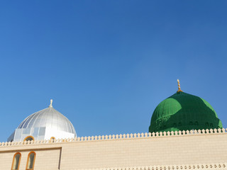 Medina, Saudi Arabia - March 25, 2018: Green dome closeup at Prophet Muhammad SAW's Mosque or Nabawi Mosque at Madinah, Saudi Arabia with selective focus and crop fragment