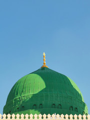 Medina, Saudi Arabia - March 25, 2018: Green dome closeup at Prophet Muhammad SAW's Mosque or Nabawi Mosque at Madinah, Saudi Arabia with selective focus and crop fragment