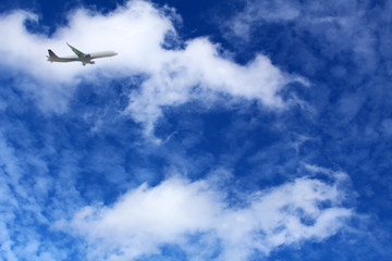 Fototapeta na wymiar White clouds against blue sky, airplane on a background of cloud