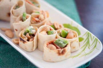 Sushi-Style Wraps with chicken pepperoni, vegetables and nuts. Healthy snacks.