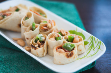 Sushi-Style Wraps with chicken pepperoni, vegetables and nuts. Healthy snacks.