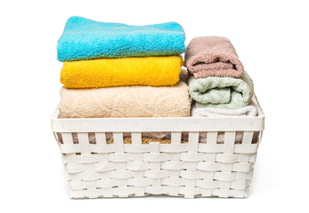 Clothes in a laundry wooden basket isolated on white background.