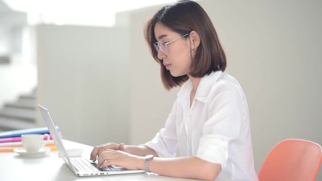 Young Asian woman working with laptop in the moden office