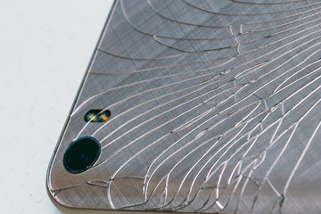Broken rear camera smartphone on white background.
