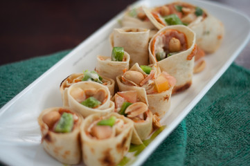 Sushi-Style Wraps with chicken pepperoni, vegetables and nuts. Healthy snacks.