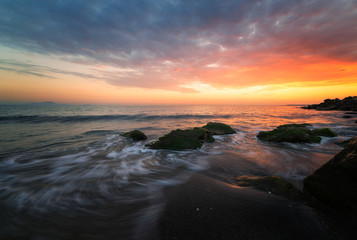 Sea sunrise, near the rocks