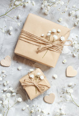 Fototapeta na wymiar Gift boxes with small white flowers and hearts