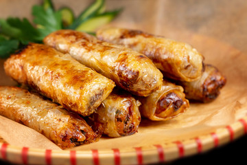 Closeup asian fried spring rolls on a plate with paper.