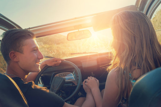 Couple in a car at sunset