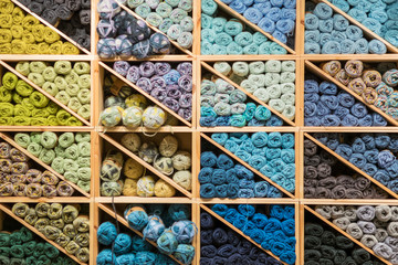 Colorful woolen yarns on shelves ready for knitting