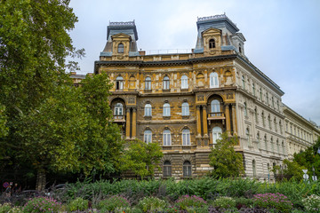Beautiful old building in the city of Budapest in the evening surrounded by trees