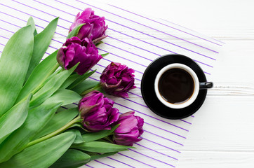 Cup of morning coffee and bouquet of spring flowers