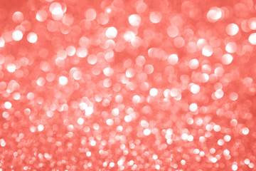 Trendy monochrome bokeh lights background in shades of coral color with copy space