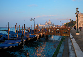 Obraz premium Venice, Italy, September 17, 2018 - Tourists walking in the early morning along the Venice Embankment