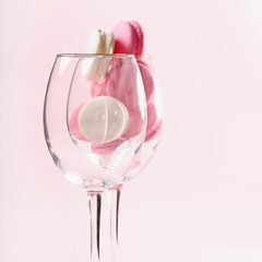 Two glasses with French pink macaroons on a pink background. Gift for Valentine's day. Ideal for holiday of international women's day.