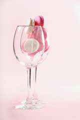 Two glasses with French pink macaroons on a pink background. Gift for Valentine's day. Ideal for holiday of international women's day.