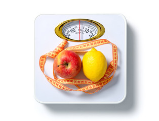 The weighing scale centimeter apple lemon on a white background isolation