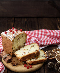 cake with raisins and dried fruits on a wooden board